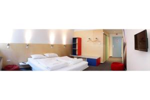 a hotel room with two beds and a tv at Maverick Budapest Soho in Budapest