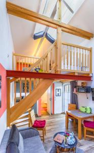 a living room with a loft with a staircase at Bahnhof Droyßig - Übernachten im Denkmal in Droyßig