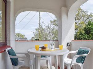 a white table and chairs on a balcony with a table at Stonecot in Wootton Bridge