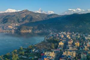an aerial view of a city and a lake with mountains at Trekkers Inn Boutique Hotel Pokhara in Pokhara