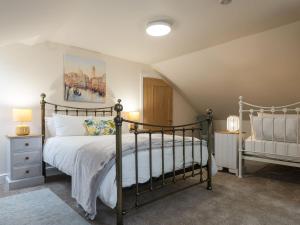 a bedroom with a bed with a black frame at Haven View - Ukc2301 in Wainfleet All Saints