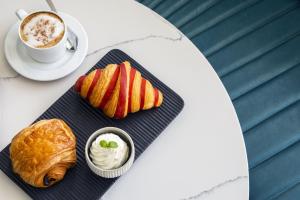 a table with a plate of food and a cup of coffee at Crowne Plaza Resort Guam in Tumon