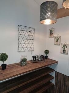 a kitchen counter with a clock on top of it at Studio dans maison avec jardin et balcon, au calme in Sérézin-du-Rhône