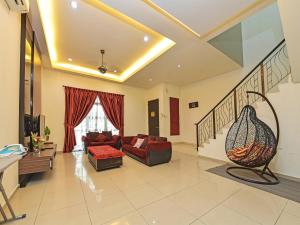 a living room with a couch and a staircase at OYO Home 90532 Casa Azlinda Muslim Homestay Ii in Johor Bahru