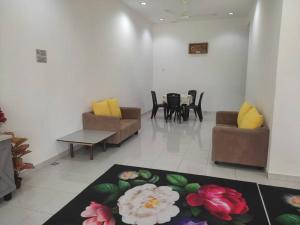 a living room with couches and chairs and a rug at HOMESTAY AT-TAQWA BATU PAHAT in Batu Pahat