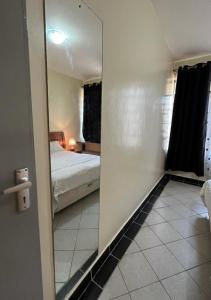a mirror in a room with a bed and a bedroom at Casa Luna in Nairobi