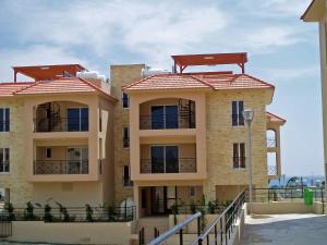 a building with red tile roofs on top of it at Mazotos Panoramic Village in Mazotos