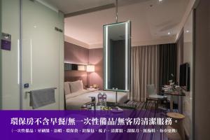 a hotel room with a bed and a mirror at WESTGATE Hotel in Taipei