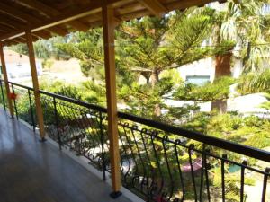 a balcony with a view of a garden at Villa Xenos in Kalamaki