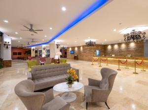 a lobby with a couch and chairs and a table at Dayang Bay Resort Langkawi in Kuah