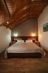 a bedroom with a large bed and wooden ceilings at Asia Hotel in Bishkek