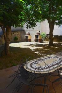 una mesa y sillas en un parque con árboles en Casa Rural Concejo 1, en La Adrada