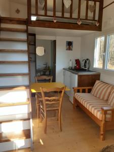a living room with a table and a couch at Tiny des Rêves in Beulotte-Saint-Laurent