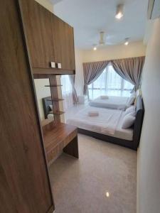 a bedroom with a bed and a large window at Deluxe Sunrise Suite 3 bedroom 2000sqft Condo Loft B side seaview above Imago Shopping Mall in Kota Kinabalu