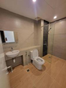 a bathroom with a toilet and a sink and a shower at Deluxe Sunrise Suite 3 bedroom Loft B side seaview above Imago Shopping Mall in Kota Kinabalu