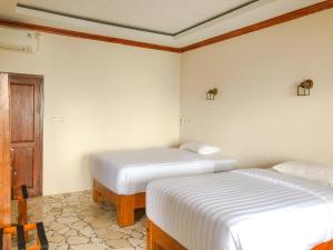 Ένα ή περισσότερα κρεβάτια σε δωμάτιο στο Edge Resort, Yogyakarta