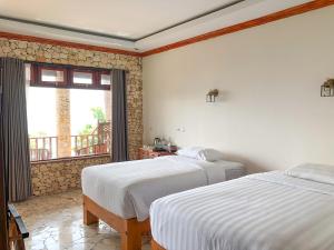 Ένα ή περισσότερα κρεβάτια σε δωμάτιο στο Edge Resort, Yogyakarta