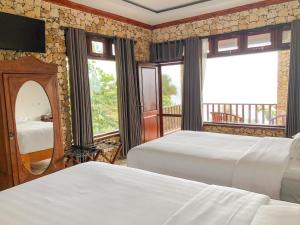 Ένα ή περισσότερα κρεβάτια σε δωμάτιο στο Edge Resort, Yogyakarta