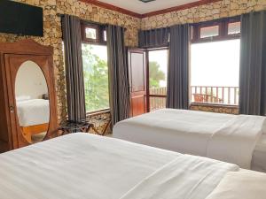 Ένα ή περισσότερα κρεβάτια σε δωμάτιο στο Edge Resort, Yogyakarta