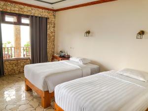 Ένα ή περισσότερα κρεβάτια σε δωμάτιο στο Edge Resort, Yogyakarta