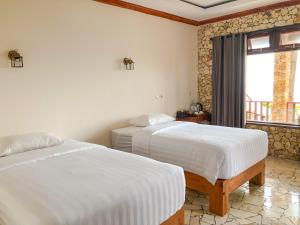 Ένα ή περισσότερα κρεβάτια σε δωμάτιο στο Edge Resort, Yogyakarta