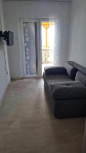 a living room with a couch and a window at Apartment Biondić in Starigrad