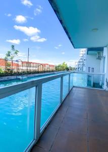 a view from the balcony of a building with a swimming pool at Marda Room By Vivo Apartment in Yogyakarta