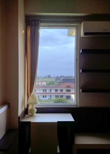 a window with a view of a building at Marda Room By Vivo Apartment in Yogyakarta