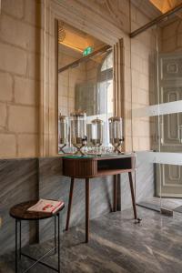 a dressing room with a table and a mirror at Marea Boutique Hotels in Sliema