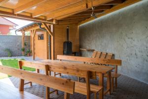 a wooden table and benches on a patio at Penzion 2 sklepy in Tasovice