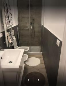 a bathroom with two toilets and a sink and a shower at Casa Ohana in Ancona