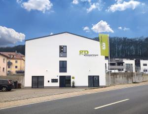 a white building on the side of a road at greenpartment Boardinghousehotel Kelheim in Kelheim