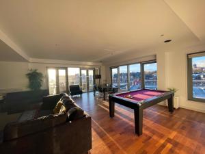 a living room with a pool table in it at Newcastle Penthouse - Sleeps 8 - City Centre - Free Parking - City Views in Newcastle upon Tyne