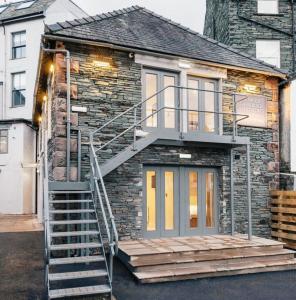 a stone house with a spiral staircase on it at Keswick Lake Road Apartments in Keswick