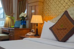 Postel nebo postele na pokoji v ubytování Vong Xua Boutique Hotel