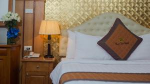 Postel nebo postele na pokoji v ubytování Vong Xua Boutique Hotel
