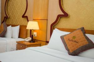 Ein Bett oder Betten in einem Zimmer der Unterkunft Vong Xua Boutique Hotel