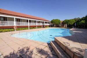 a large swimming pool in front of a building at 128 @ The Dunes in Plettenberg Bay