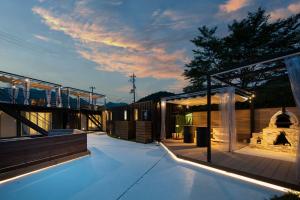 a house with a walkway and a building with lights at SEN RETREAT CHIKATSUYU - Kumano Kodo Gateway in Tanabe