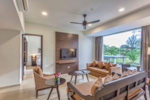 a living room with a couch and a table at Camar Resort Langkawi in Pantai Cenang