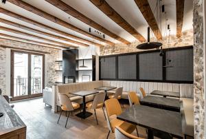 a restaurant with tables and chairs in a room at ABBI SUITES Casa Rural, Suites & Spa in Bocairent