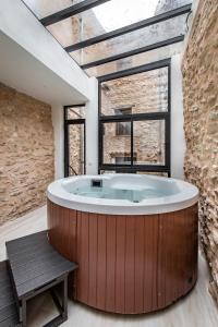 a large bath tub in a room with a large window at ABBI SUITES Casa Rural, Suites & Spa in Bocairent