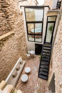 a building with two tables and a spiral staircase at ABBI Suites Casa Rural, Suites & Spa in Bocairent