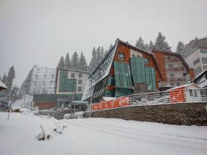 a group of buildings in a snow covered city at Hotel Blanca Resort & Spa in Vlasic