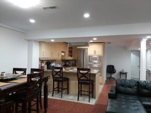a kitchen and living room with a table and chairs at Guest House Room No 02 in Mississauga
