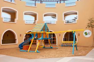 a playground in front of a building at Jaz Dar El Madina in Coraya Bay