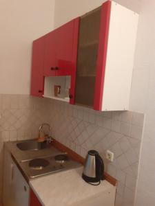 a kitchen with a sink and a counter top at Apartments Maletić in Kaštela +53 photos