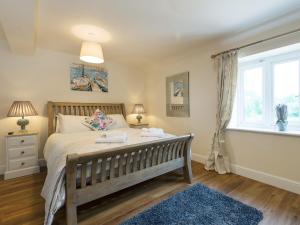 a bedroom with a large bed and a window at Church View - Ukc2302 in Wainfleet All Saints