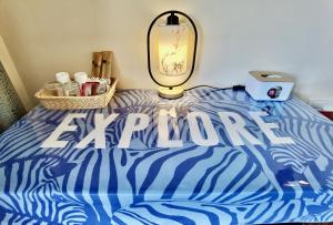 a blue and white bed with the word arrive on it at Junshe Boutique Guest House in Guilin