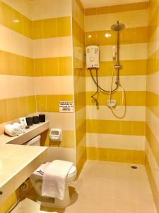 a bathroom with a shower and a toilet at The Luka Guesthouse and Restaurant in Patong Beach